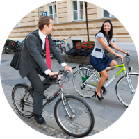 Guy and girl on two bikes, driving around