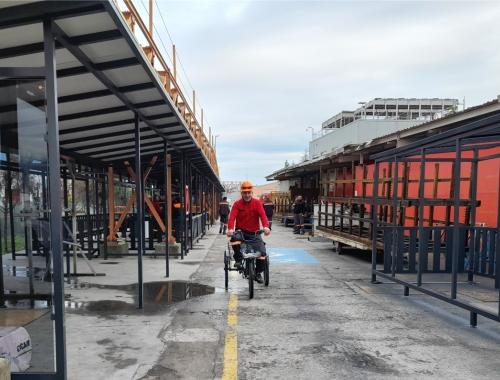 Factory worker riding bicycle on company cycle path 